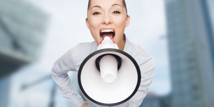 screaming businesswoman with megaphone