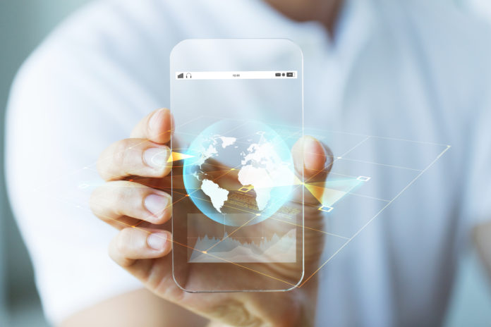 close up of hand with earth globe on smartphone