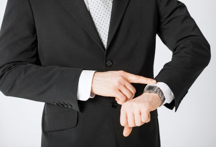 man looking at wristwatch