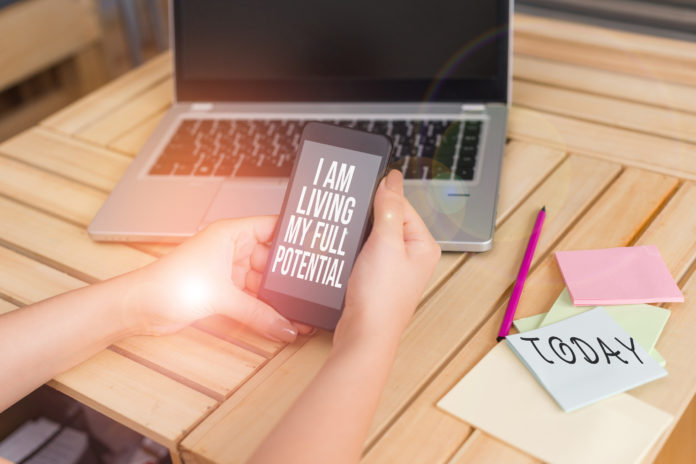 Text sign showing I Am Living My Full Potential. Conceptual photo Embracing opportunities using skills abilities woman laptop computer smartphone office supplies technological devices. habilidades tecnológicas